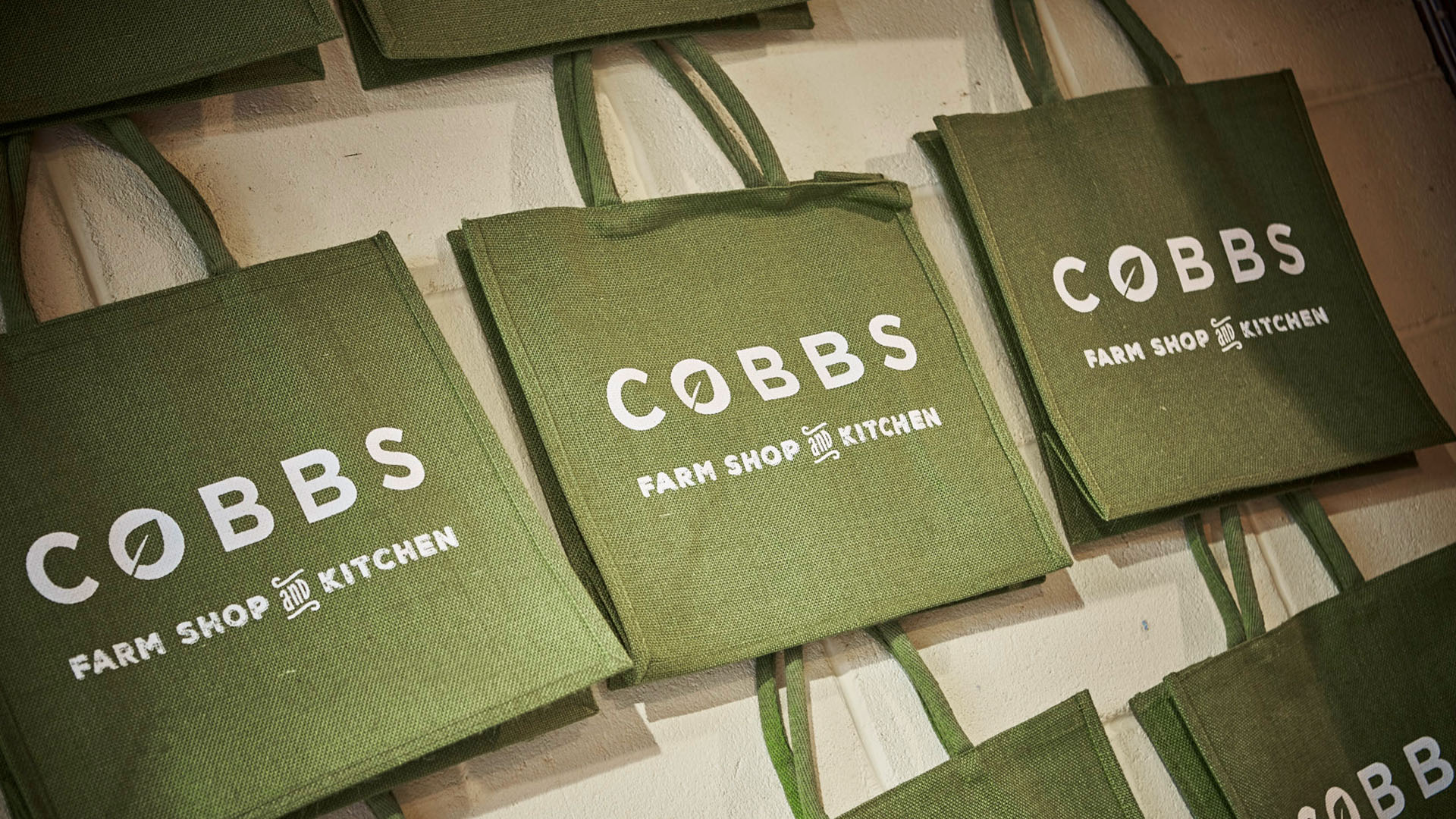 cobbs shopping bags hanging on a wall